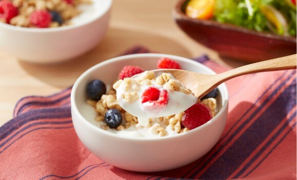 yogurt fruit and granola in a bowl