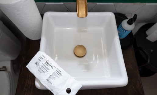 single-use catheter on bathroom sink