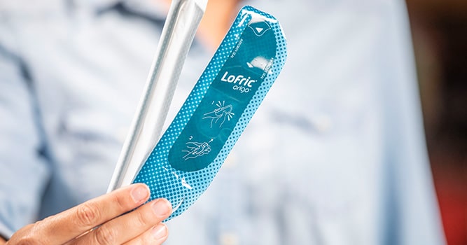 woman holding a lofric origo catheter