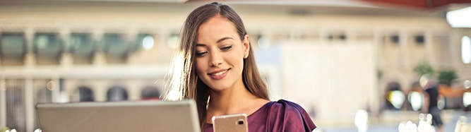 woman smiling looking down at laptop