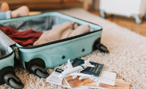 packed suitcase for travel with passport