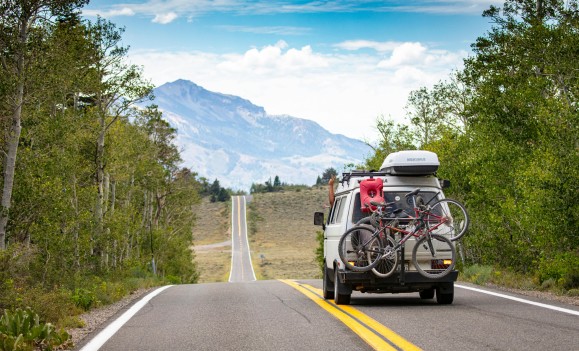 van on road trip toward mountains