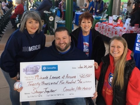 180 Medical employees presenting check to Cassandra Switalski of Miracle League of Arizona