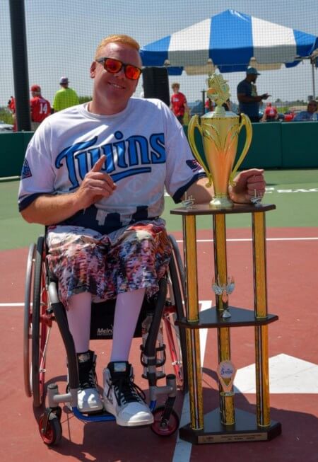 Brendan posing with trophy - Minnesota Twins Wheelchair Softball Champs