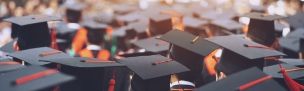 students with graduation hats