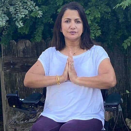 Meena doing adaptive yoga