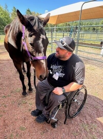 ryan with horse at camp with a ramp