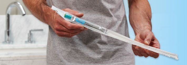 man holding gentlecath glide hydrophilic male catheter